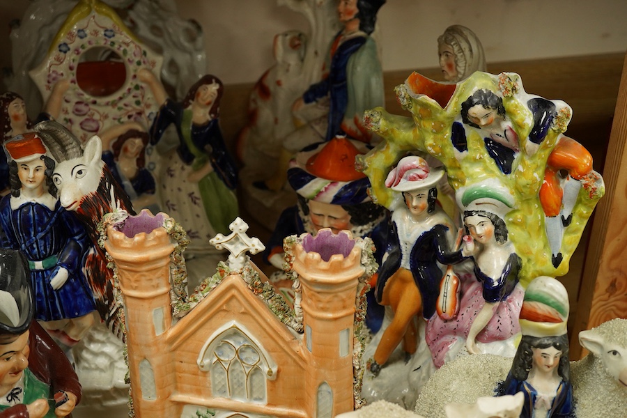 A collection of Victorian Staffordshire pottery figures, largest 32cm high